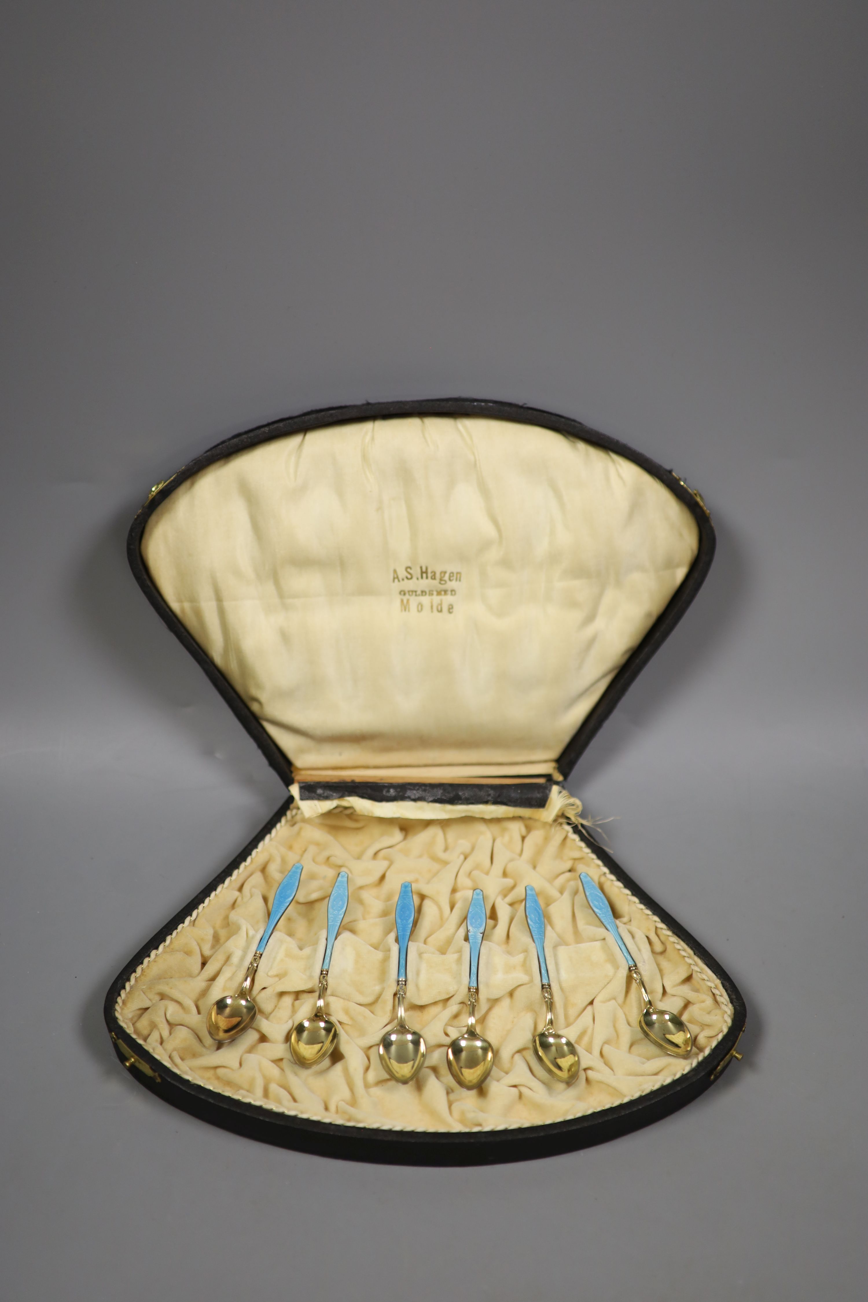 A cased set of six Norwegian gilt white metal and enamel coffee spoons (enamel a.f.).